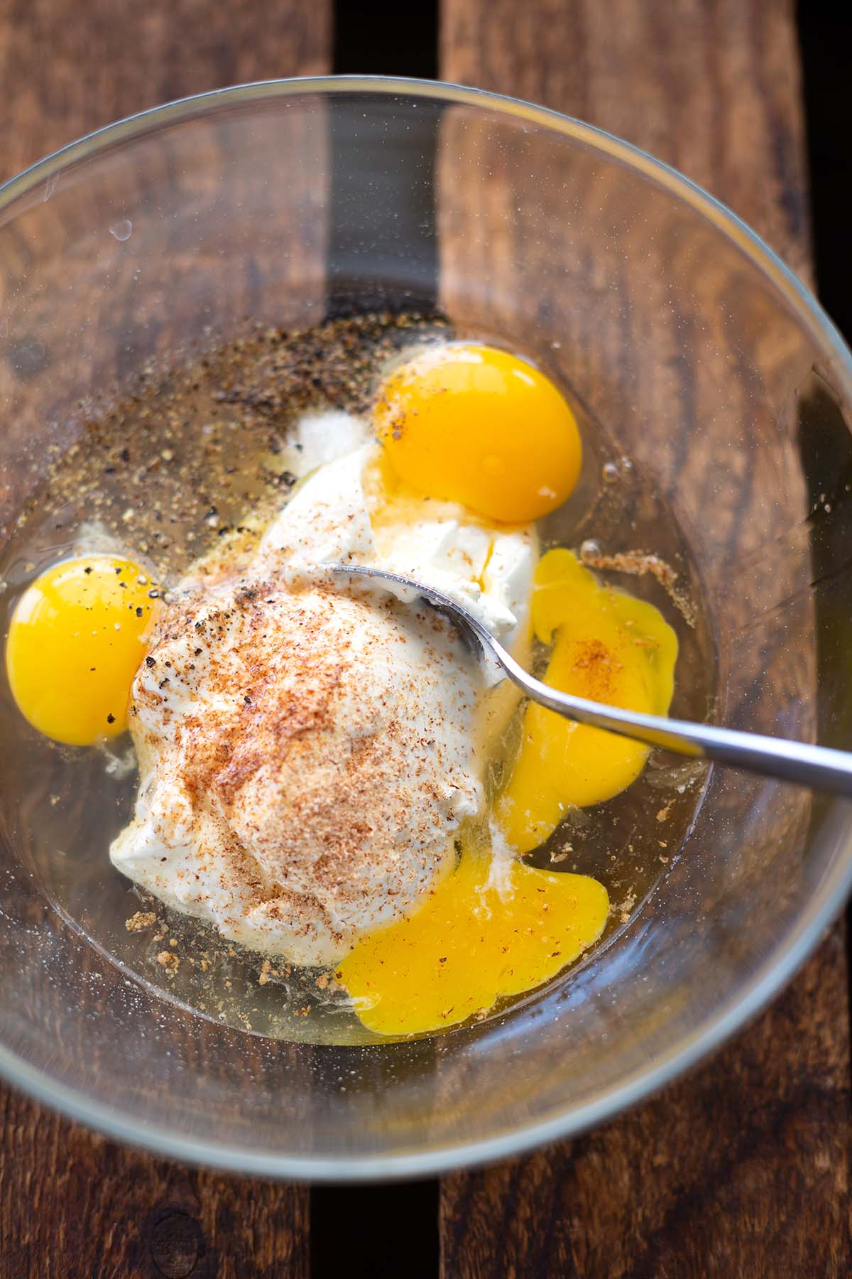 Zutaten für den Guss für die Spinat-Quiche mit Feta: Eier, Schmand und Gewürze in einer Schüssel verquirlen